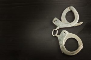 two handcuffs on a black background