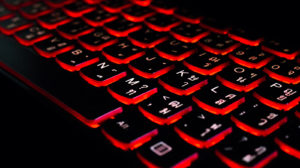 a close up of a keyboard with red lights