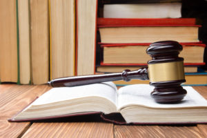 law books and gavel on wooden table