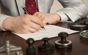 a man in a suit is signing a document