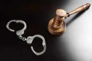 handcuffs and gavel on a black background
