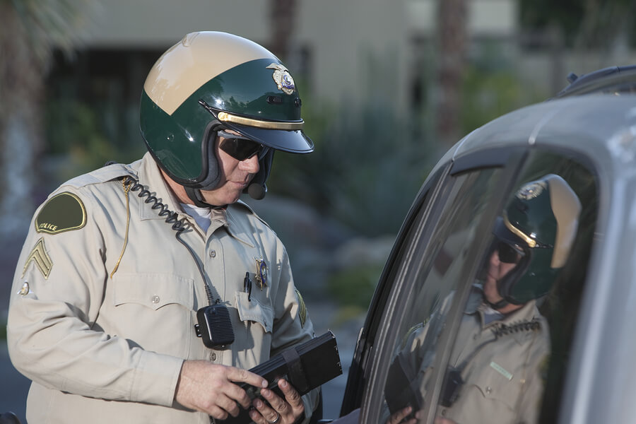 a man in a police uniform is checking his cell phone