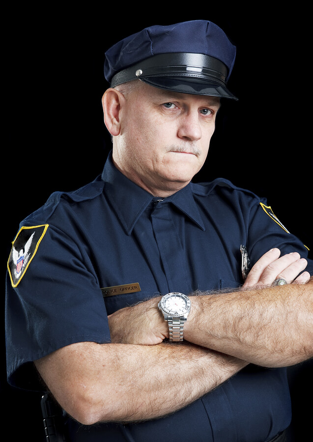 a man in a police uniform with his arms crossed