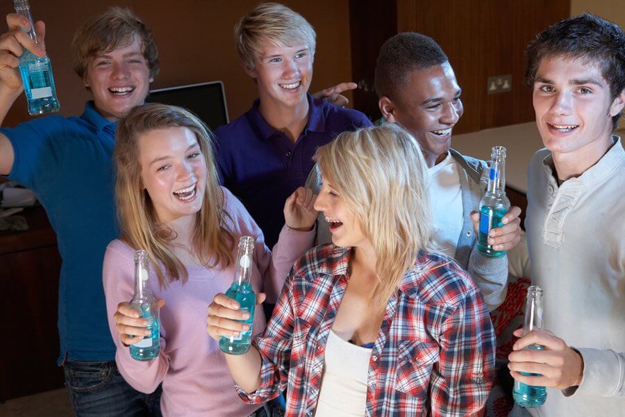 a group of young people holding up drinks
