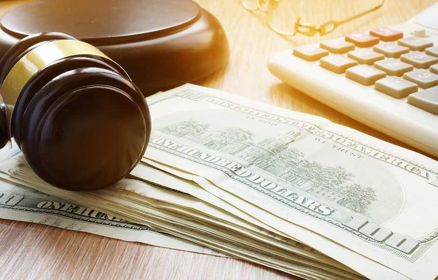 a judge's gavel and money on a desk