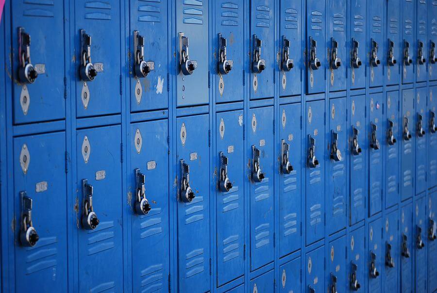 a row of blue lockers with keys on them