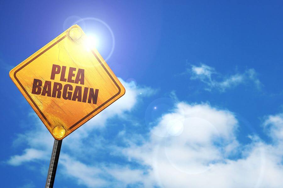 a yellow sign with the word plea bargain on it