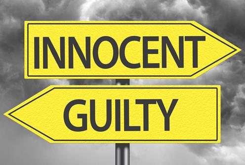 two yellow signs pointing in opposite directions with the words innocent guilty