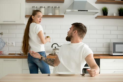 a man and woman in the kitchen