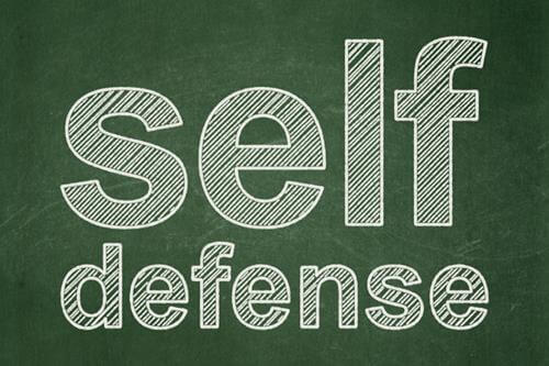 self defense written in chalk on a blackboard photo
