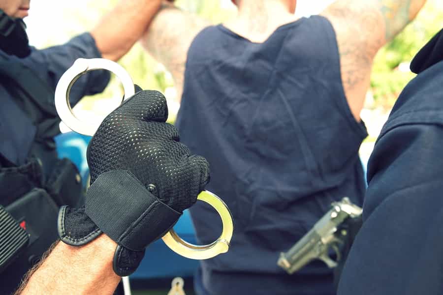 a police officer holding a pair of handcuffs