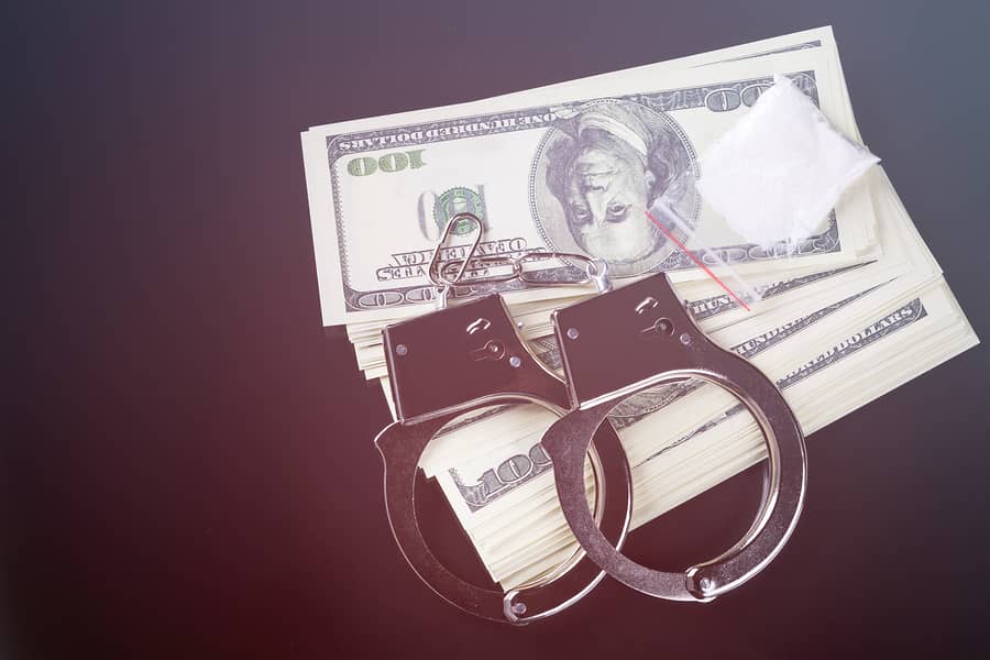 handcuffs and money on a dark background