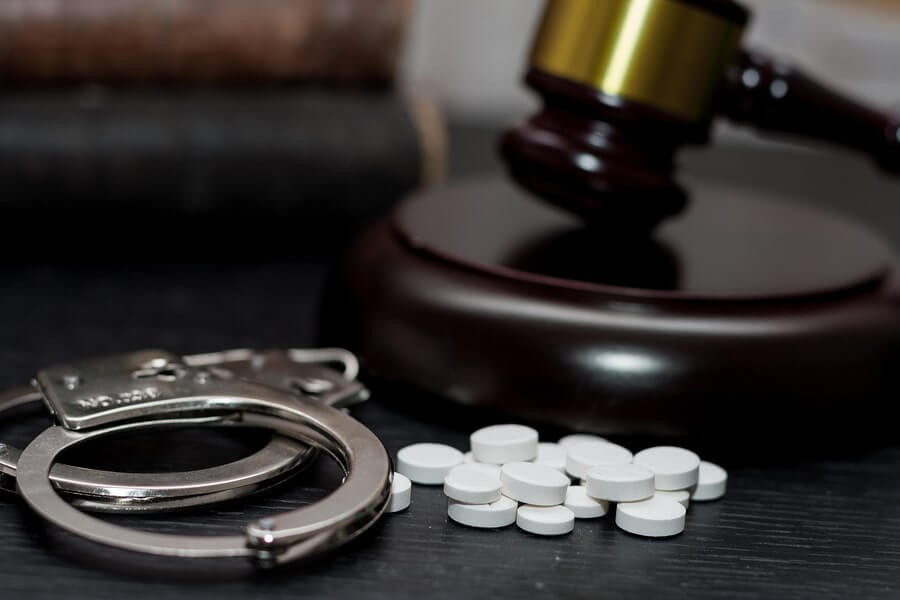 pills and a judge's gavel on a table