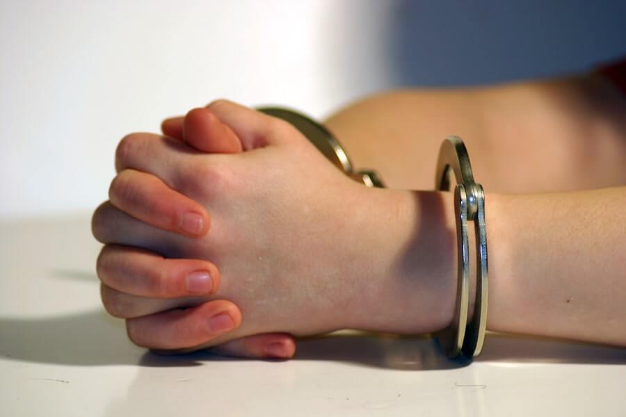 a person's hands are clasped together with handcuffs