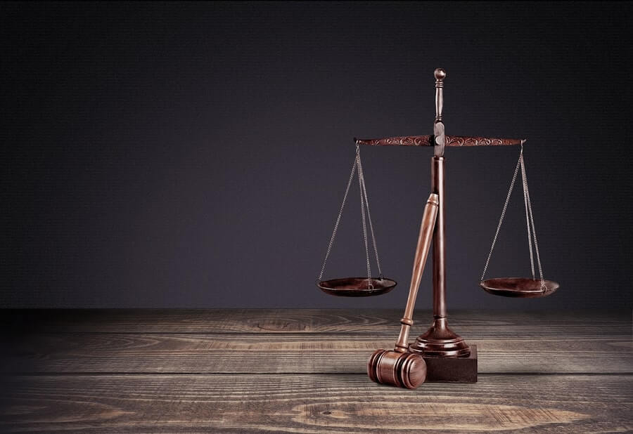 a wooden scale with a gavel on top of it