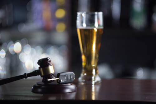 a gavel and a beer glass on a bar