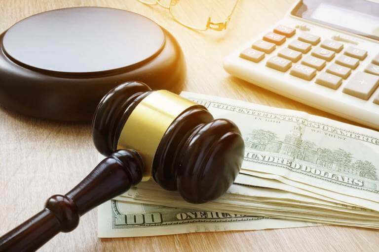 a judge's gavel and money on a desk